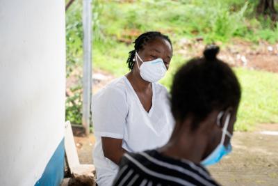 Mariama Koroma (pseudonym)(right), a patient at Lakka Government Hospital, talks with Zainab Jalloh, a state-registered nurse.