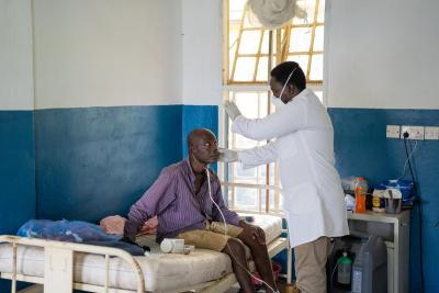 Dr. Ronnie Harding (right), Medical Superintendent of Lakka Government Hospital, examines patient Jusufu Macavoray during his rounds at the hospital.