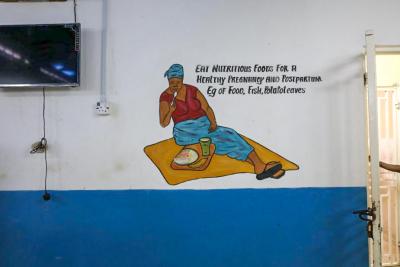 A wall with a graphic of a woman eating